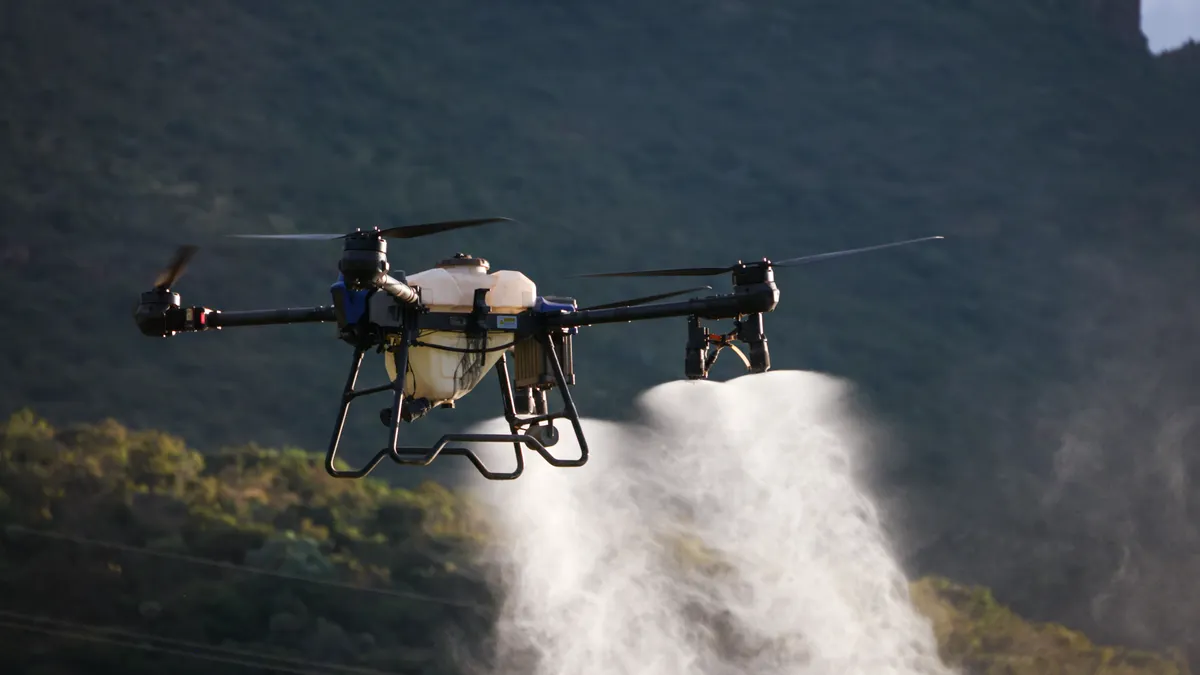 Drone spraying crop field