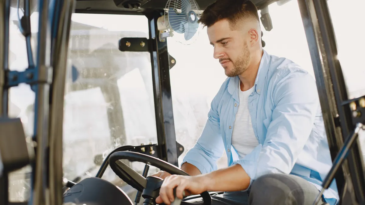 man operating a tractor in the cab